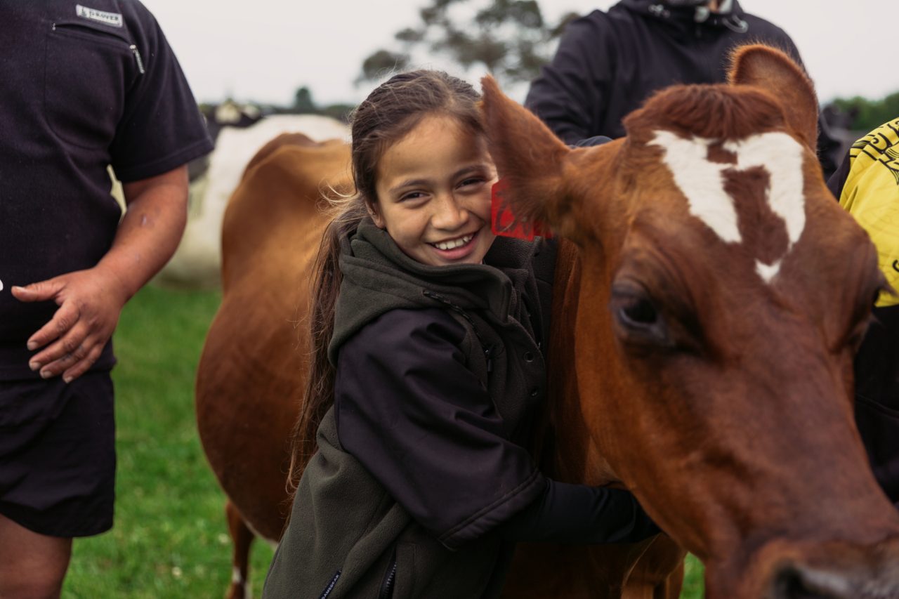 Girl hugging a cow on farm