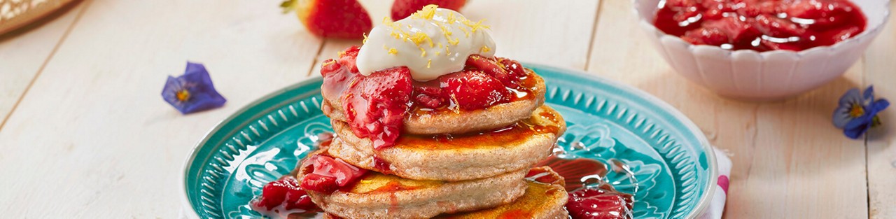 Oats pancakes stuffed with lemon zest cream cheese and strawberry compote