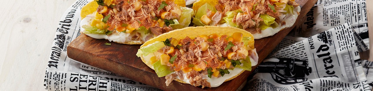 Tacos shells with cheese tuna corn garnish with fresh coriander