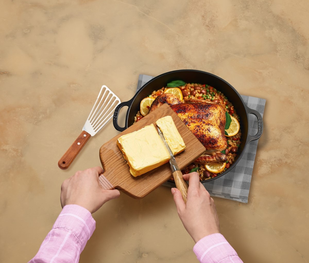 Woman adding Anchor butter to chicken dish