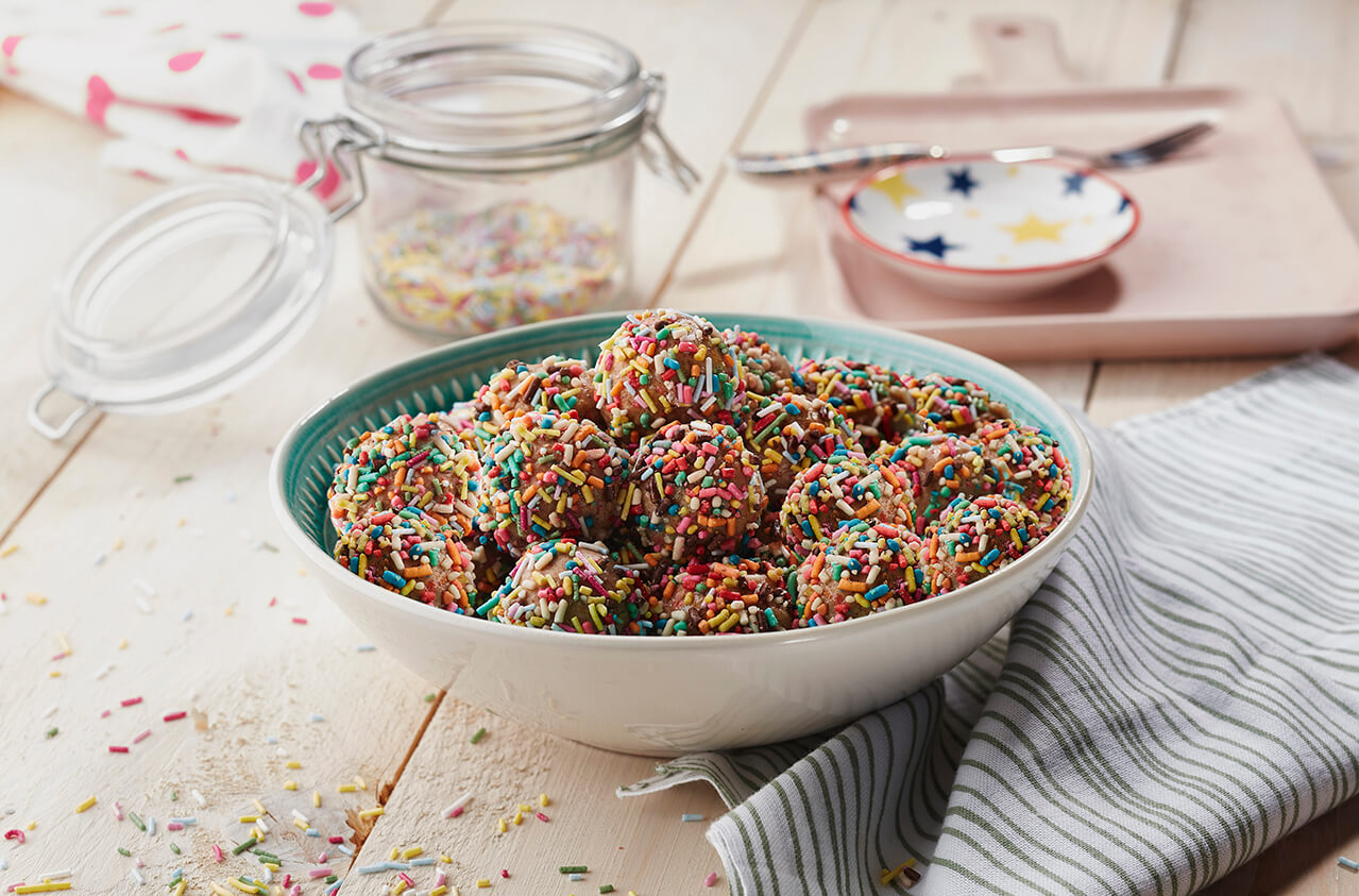 Milk powder and peanut butter balls with rainbow sprinkles