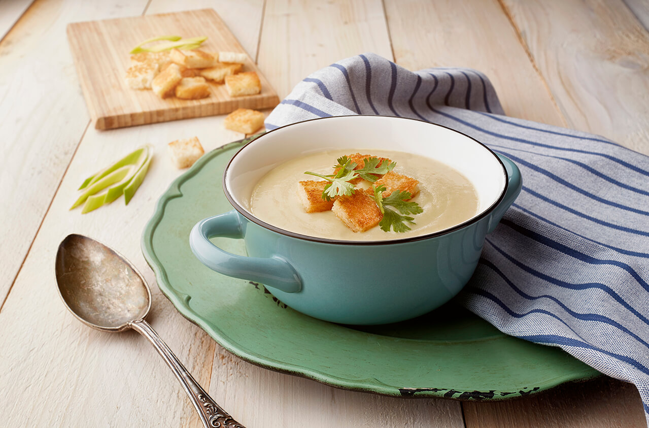 Silky leek and potato soup with mustard croutons and coriander garnish